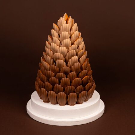 Luxury chocolate madeleine tower with ombré caramel to milk chocolate madeleines on a white round base